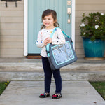 Child holding the 3-IN-1 Travel Tray and Tablet Holder by carrying shoulder strap