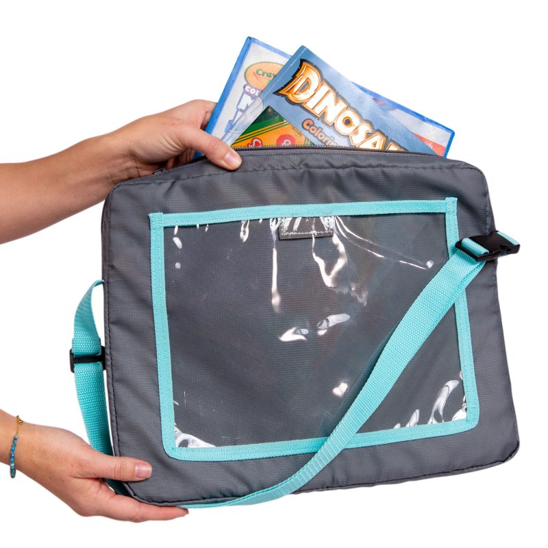 Coloring books being placed in the zippered pocket of the 3-IN-1 Travel Tray and Tablet Holder