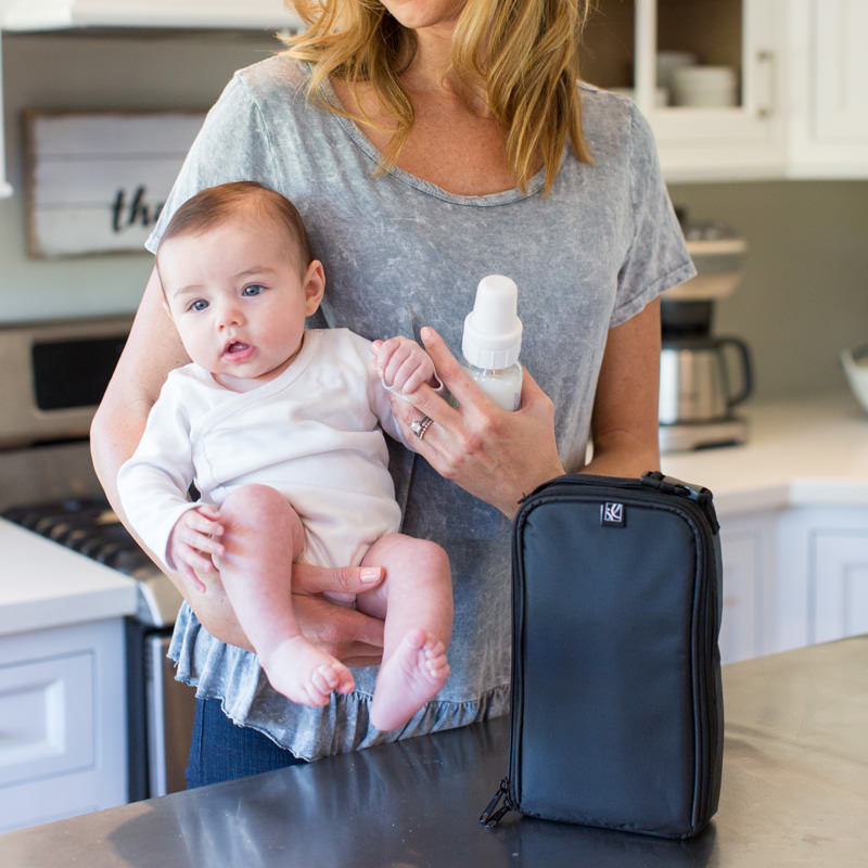 Woman holding baby with Pack ‘N Protect Cooler Bag for Glass Bottles and Containers sitting on counter