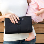 Woman holding baby and Full Body Changing Pad, black folded