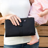 Woman holding baby and Full Body Changing Pad, black folded