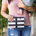 Woman holding baby and Full Body Changing Pad, black and white stripe