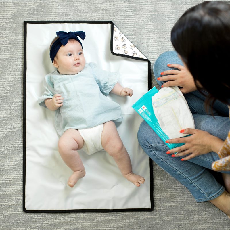 Disney Baby Full Body Changing Pad Mickey Minnie Ivory unfolded with baby laying on it