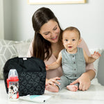 Woman and baby sitting at table with Disney Baby MaxiCOOL Four Bottle Cooler, Mickey Black