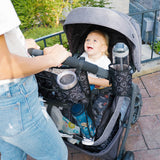 Disney Baby Cup ‘N Stuff Stroller Cup Holder hanging on stroller with water bottle in it