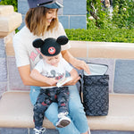 Woman sitting with child reaching into Disney Baby 6 Bottle Cooler, Mickey Black