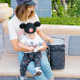 Woman sitting with child reaching into Disney Baby 6 Bottle Cooler, Mickey Black
