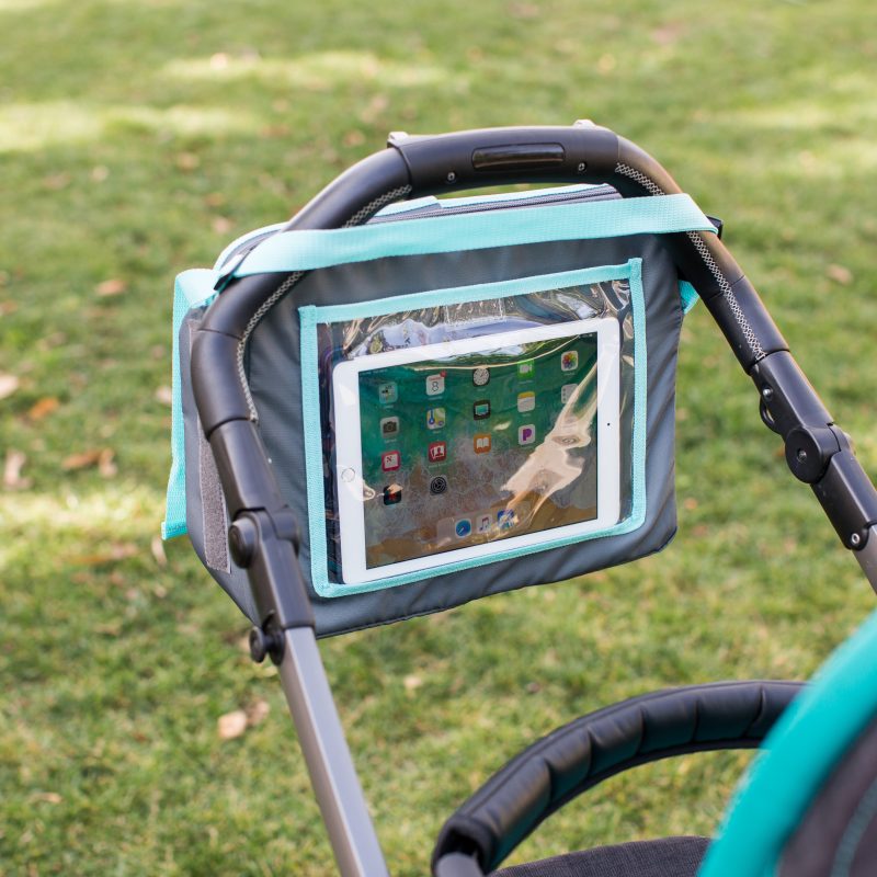 3-IN-1 Travel Tray and Tablet Holder hanging on stroller handle with ipad in it