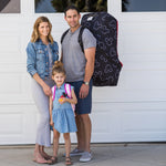 Family standing together with man carrying the Disney Baby Ultimate Padded Backpack Car Seat Travel Bag, Mickey Black