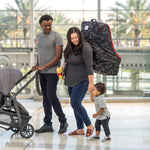Man pushing stroller and woman carrying the Disney Baby Ultimate Padded Backpack Car Seat Travel Bag, Mickey Black