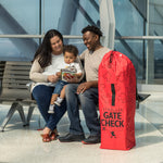 Family sitting next to the Disney Baby Gate Check Travel Bag for Umbrella Strollers