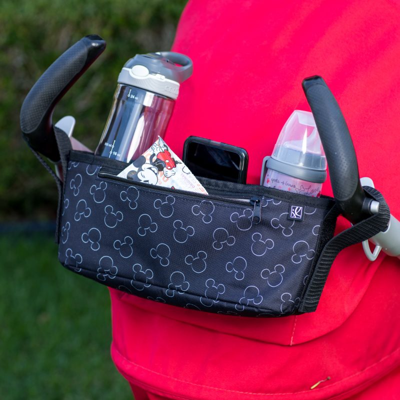 Disney Baby Universal Stroller Organizer hanging on stroller with accessories in it