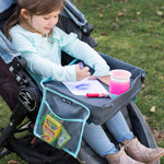 Child sitting in stroller with the 3-IN-1 Travel Tray and Tablet Holder placed on their lap and drawing on it
